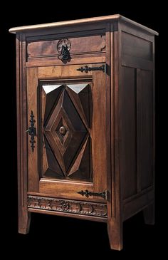 a wooden cabinet with an intricate design on the door