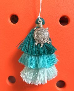 a turtle ornament hanging on an orange wall