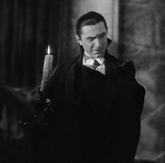 black and white photograph of a man holding a candle