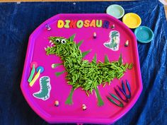 a child's play tray with dinosaur stickers on it