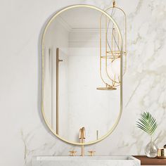 a bathroom with marble counter tops and gold fixtures on the wall, along with a round mirror