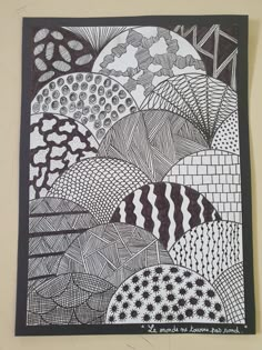 a black and white drawing on a wall with an abstract design in the middle,