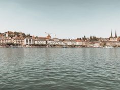 some buildings are on the shore of a lake