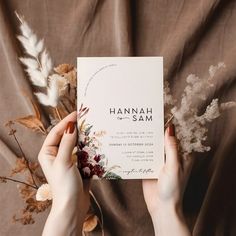 two hands holding up a card with the word hannah sam written on it and flowers