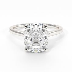 an oval cut diamond engagement ring on a white background