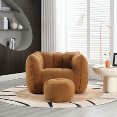 a living room with a chair and ottoman