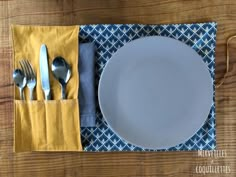 a place setting with silverware and napkins