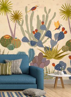 a blue couch sitting in front of a wall with cactus and plants on it's side