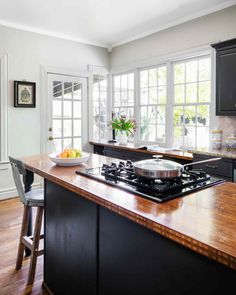 a kitchen with an island and stove top