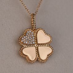 The Luck and Love Clover Gold Pendant is a beautifully designed piece of jewelry that symbolizes good fortune and love. It features a clover-shaped pendant crafted in high-quality gold, with intricate detailing and a shiny finish. The clover is known to symbolize luck, with each leaf representing a different aspect of good fortune - faith, hope, love, and luck. The pendant is also adorned with a heart-shaped centerpiece, symbolizing love and affection. This combination of luck and love makes the pendant a meaningful and sentimental piece to wear or gift to a loved one. The necklace is versatile and can be worn everyday or for special occasions, adding a touch of elegance and charm to any outfit. Overall, the Luck and Love Clover Gold Pendant is a stunning piece of jewelry that carries a po Elegant Good Luck Jewelry With Flower Charm, Outfit Overall, Luck Symbol, Love And Luck, Clover Jewelry, Faith Hope Love, Hope Love, Gold Collection, Good Fortune