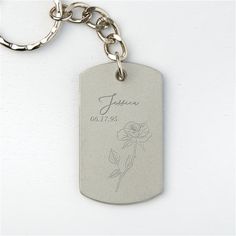 a silver dog tag with a rose on it's side and the name jaleen