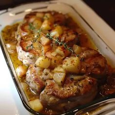 some meat and potatoes are in a glass dish