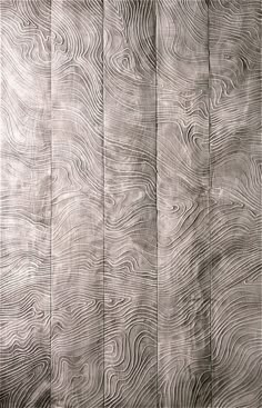 an old wood paneled wall with wavy lines in grey and white colors, as well as the grains on it