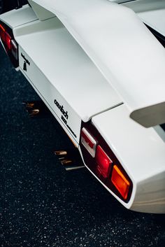 the back end of a white sports car