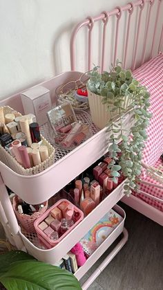 two trays with cosmetics and other items in them next to a pink chair on the floor