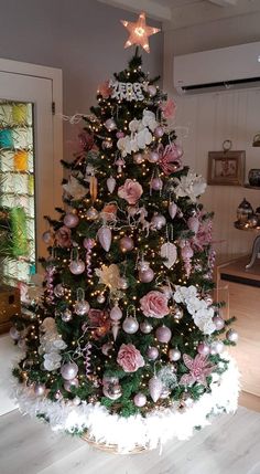 a christmas tree decorated with pink and white ornaments