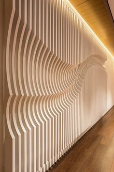 the wall is made up of white wavy lines and wood flooring, along with a wooden ceiling