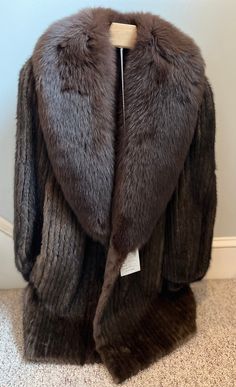 Rare find!  Vintage (1960s?) Mink Coat-unworn with original tag!- featuring mahogany-dyed fox collar and wrist hem. Fur sourced from Finland and Norway. This coat was NEVER worn- and still bears the original tag with  price that at the time was over $3800. The lining is 100% acetate (still soft and shiny) and bears the hand-sewn monogram initials of the original owner. Mint condition.  Measurements: marked women's size 6.  34" long collar to hem (back) 24" shoulder to wrist 17" across bust 12" arm hole 3" wrist hole Please read description carefully and view all photos. I describe and photograph all condition issues that I am aware of. I do my best to research and give the most accurate information regarding the item, but no one is perfect! Please do your own research if you are unsure abo Fox Collar, No One Is Perfect, Mink Coat, Jewellery Designer, Winter Looks, Monogram Initials, Vintage 1960s, Collectible Figurines, Hand Sewn