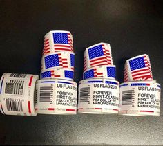 four rolls of us flags are stacked on top of each other