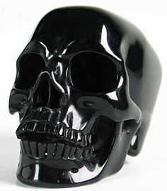 a black plastic skull head on a white background