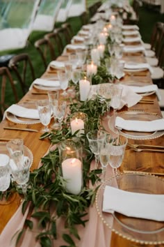 a long table is set with candles and place settings