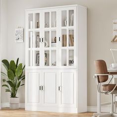 a white bookcase in the corner of a room with a desk and chair next to it