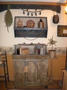 an old fashioned kitchen with lots of stuff on the counter and cupboards above it