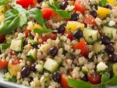 a white plate topped with couscous and veggies