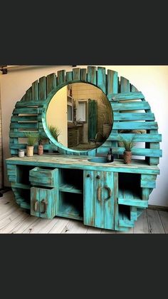 a mirror sitting on top of a wooden table next to a wall mounted shelf with potted plants