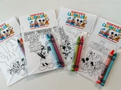 three mickey mouse coloring pages with markers and crayons in them on a table