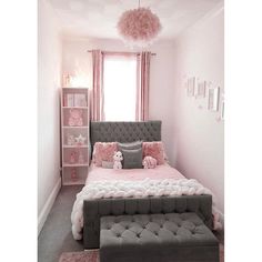 a bedroom with pink and gray decor in the corner