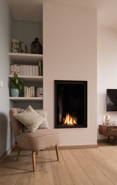 a living room with a fire place and bookshelves