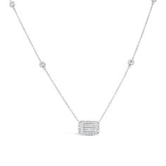 a white gold necklace with diamonds on the sides and a baguette in the middle