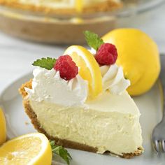 a slice of lemon pie with raspberries on top