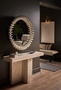 a mirror on the wall above a console table