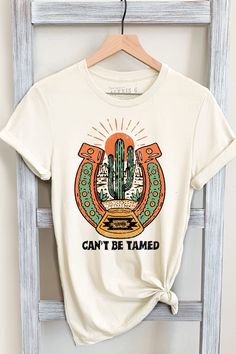 CAN'T BE TAMED GRAPHIC TEE Our Shirts are Authentically Designed and Hand Screen Printed for Best Quality *Process where the ink is dyed into the shirt and graphic will not peel away -Proudly Hand Pressed in Los Angeles, CA. -30 Singles. 100% Washed Cotton -Comfortable and Very Soft -Style by Rolling up the Sleeves, Tie a Side Knot, Front Tuck... SIZE AND FIT *Please refer to the last photo option for measurements WASHING AND CARE -Machine Wash with Like Colors -Tumble Dry Low -Do Not Bleach -Do Tattoos Western, Western Graphics, Country Graphic Tees, Southern T Shirts, Can't Be Tamed, Cactus Desert, Western Clothing, Front Tuck