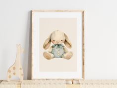 a stuffed animal sitting on top of a wooden shelf