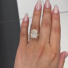 a woman's hand with a diamond ring on it