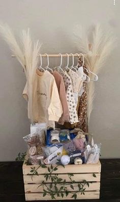 a wooden crate filled with lots of clothes and other items sitting on top of a table