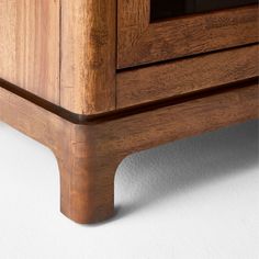 a close up view of a wooden cabinet with glass doors and wood trimmings