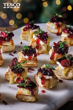 small cranberry and cheese appetizers on a platter with christmas lights in the background