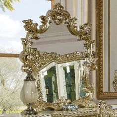 an ornately decorated gold vanity with mirror