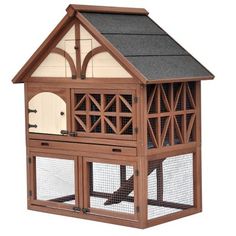 a large wooden bird house with a blue roof and two doors on the front side