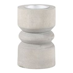 a white candle holder made out of concrete