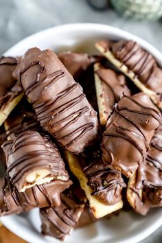 a white bowl filled with chocolate covered cookies