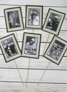 six black and white photos are arranged on toothpicks in front of a wooden wall