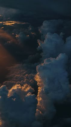 the sun shines through clouds as seen from an airplane