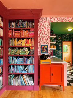 a room with bookshelves full of colorful books