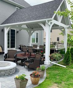 an outdoor patio with chairs, table and fire pit