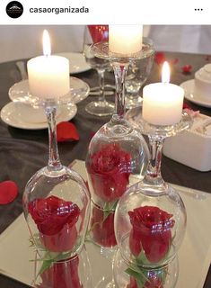 a table with candles and wine glasses on it